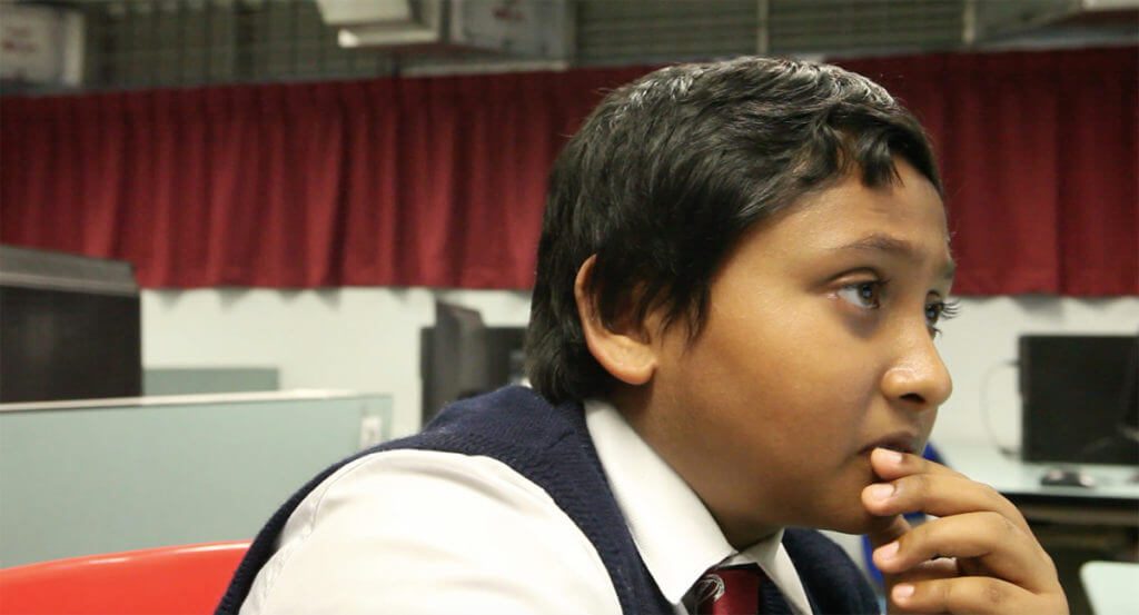 close up portrait with a student face, in a classroom