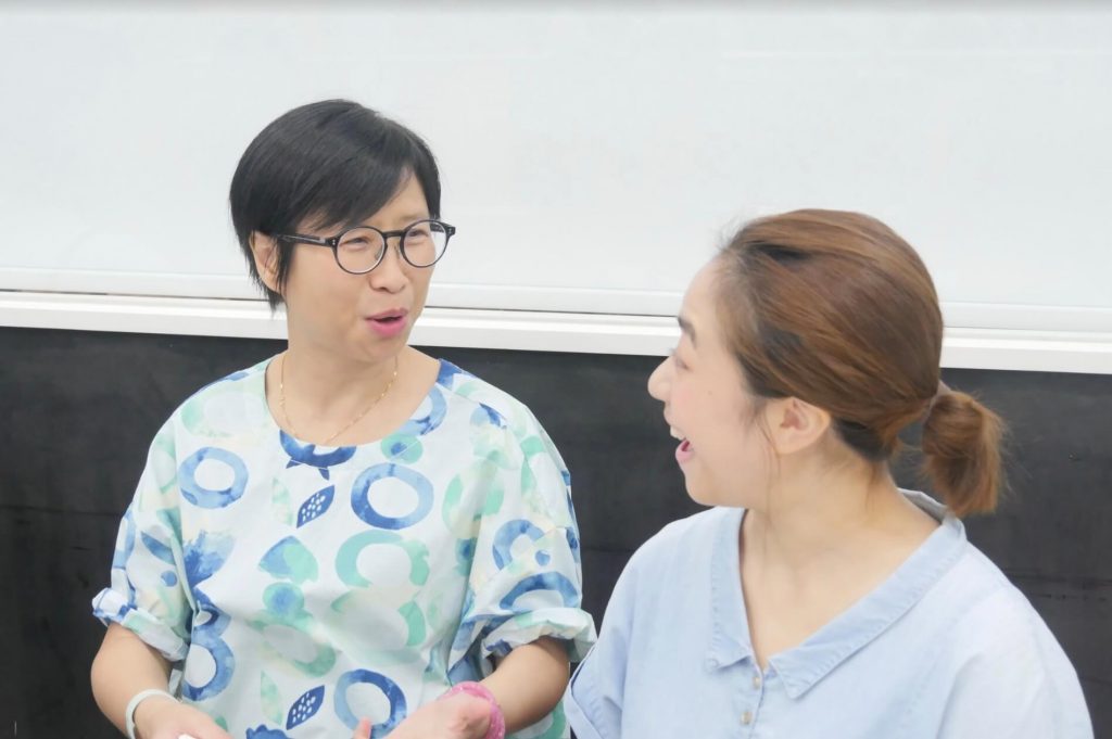 2 ladies are talking to each other and laughing